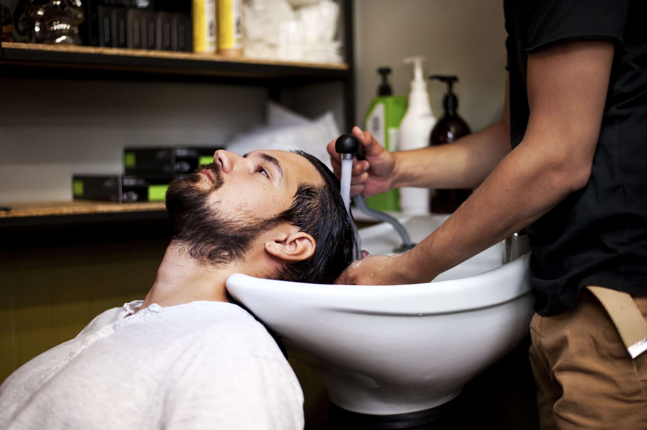 customer getting wash after haircut scaled